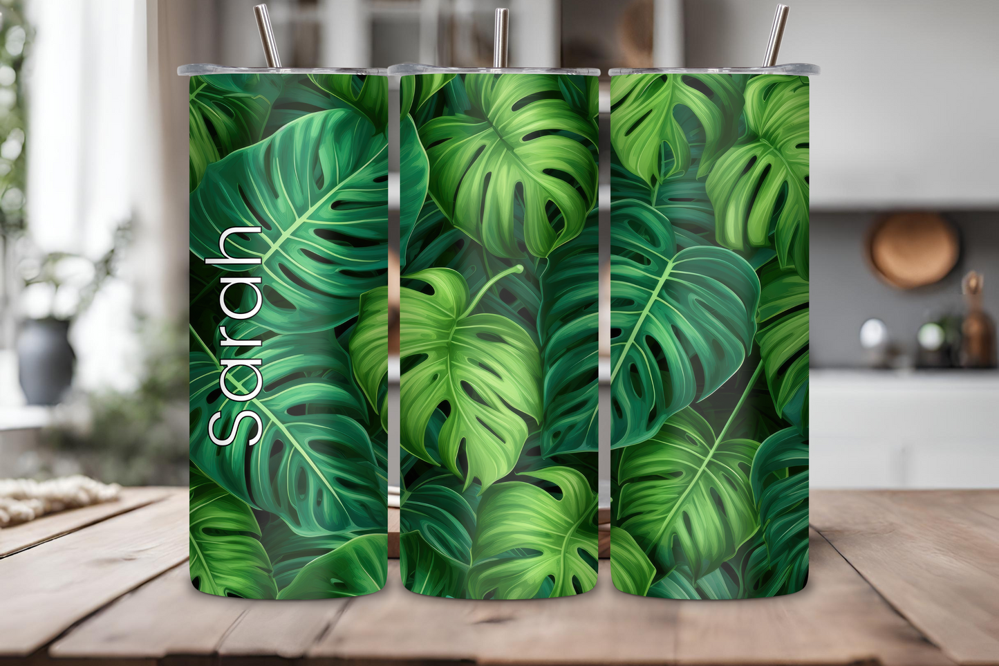 Customizable tumbler featuring a vibrant monstera leaf pattern with a sleek green aesthetic, personalized with a name up to 12 characters.