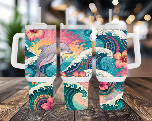 Three 40OZ tumblers featuring a jumping dolphin surrounded by ocean waves and tropical flowers, each with a white lid and straw, displayed on a wooden surface with a blurred indoor background.